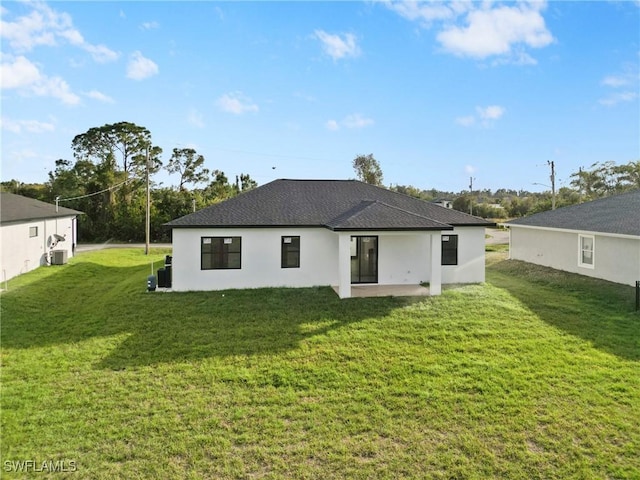 back of property featuring a yard, central AC unit, and a patio