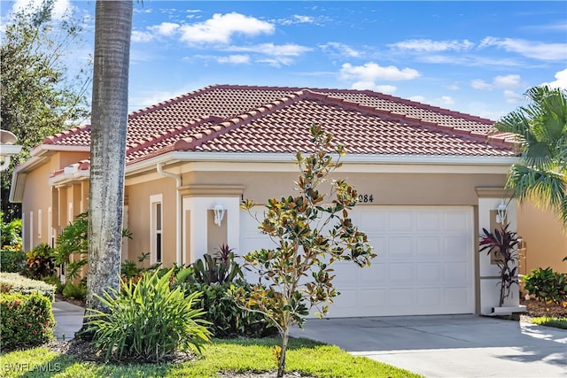 mediterranean / spanish house with a garage