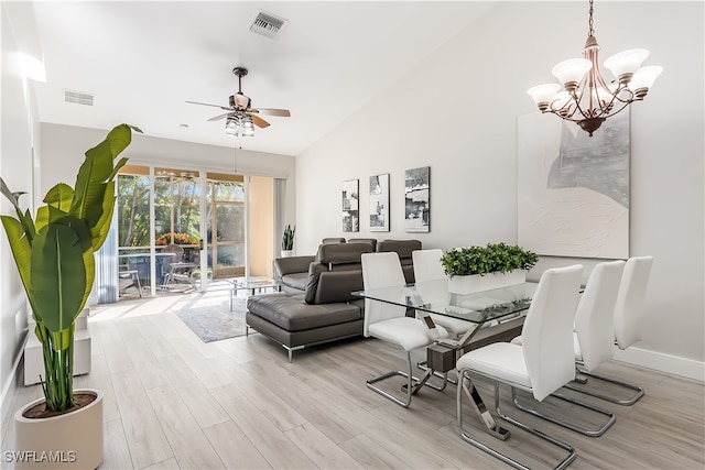 living room with ceiling fan with notable chandelier, light wood-type flooring, and high vaulted ceiling