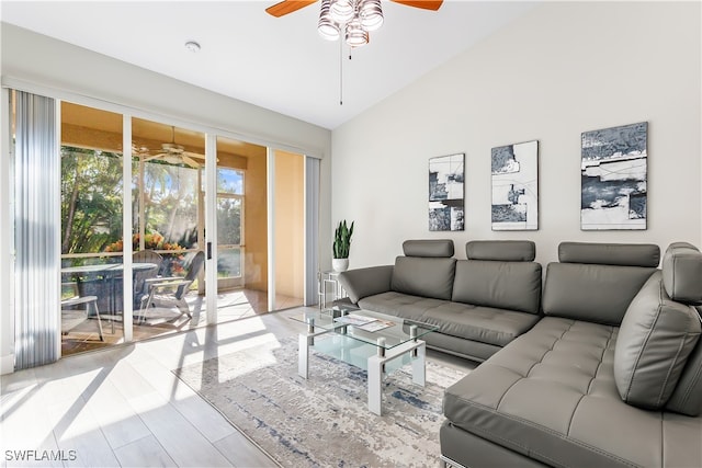 living room featuring high vaulted ceiling, light hardwood / wood-style floors, and ceiling fan