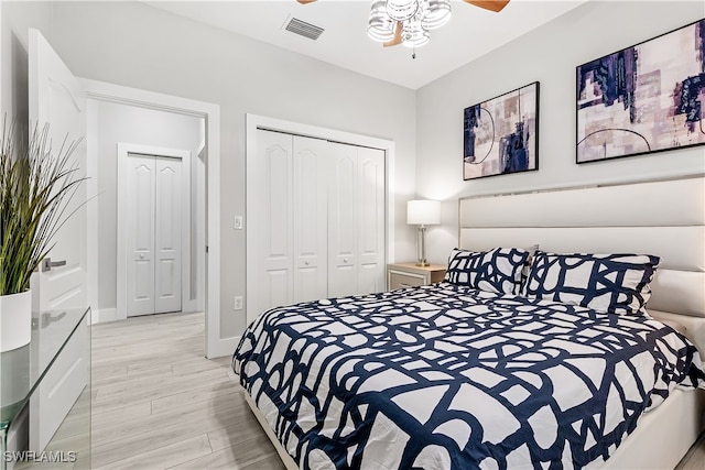 bedroom with light hardwood / wood-style floors, ceiling fan, and a closet