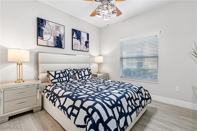 bedroom with ceiling fan and light hardwood / wood-style flooring