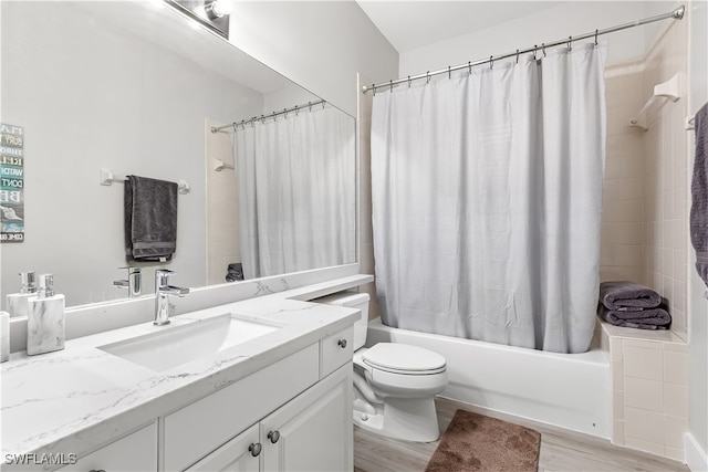 full bathroom with shower / bath combination with curtain, hardwood / wood-style flooring, vanity, and toilet