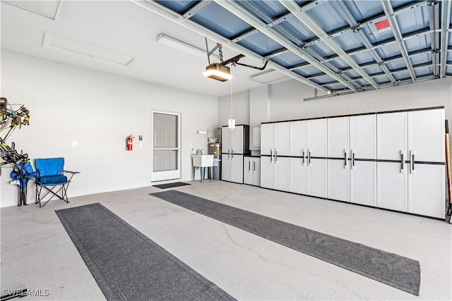 garage featuring a garage door opener and white refrigerator