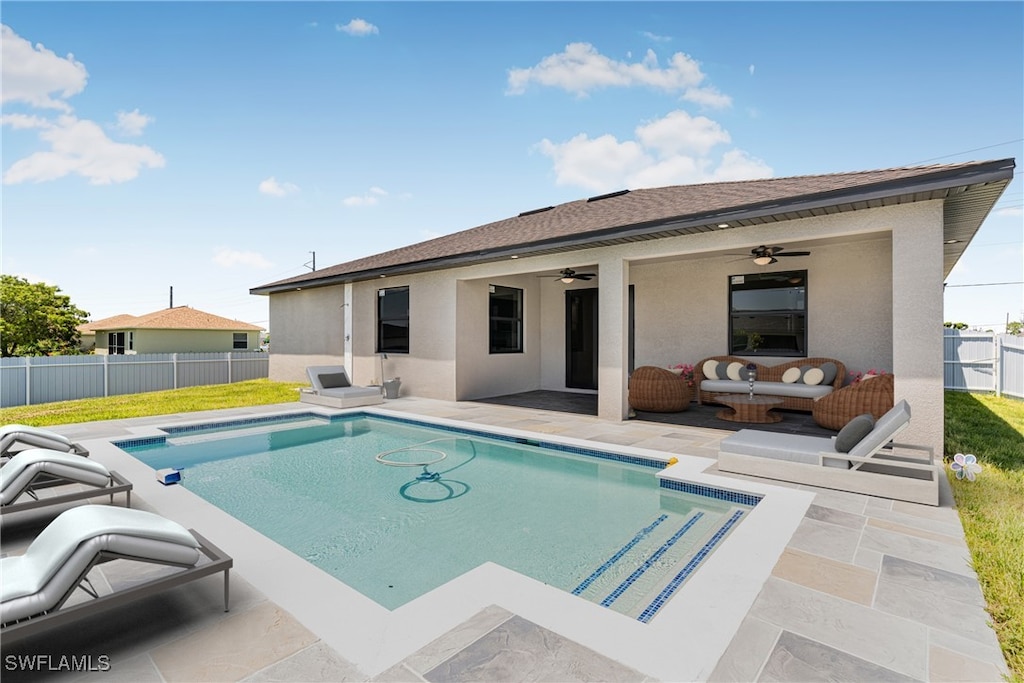 view of swimming pool featuring a fenced in pool, a fenced backyard, ceiling fan, a yard, and a patio area