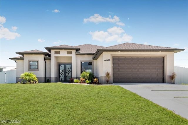 prairie-style house with a garage and a front yard