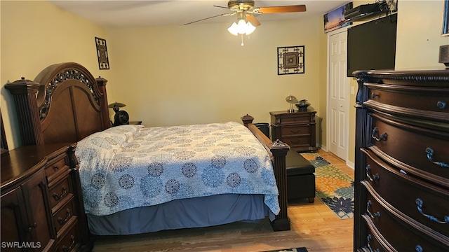 bedroom with a closet, ceiling fan, and light hardwood / wood-style flooring