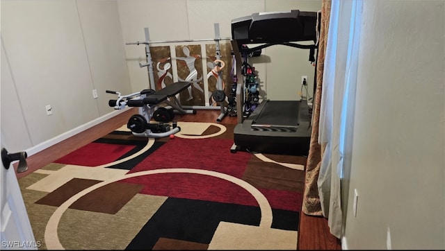 exercise area with basketball hoop and hardwood / wood-style flooring