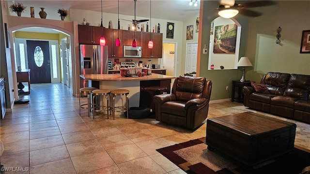 living room with light tile patterned floors and ceiling fan