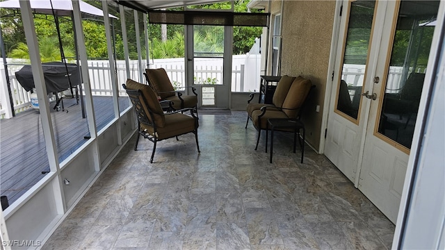 sunroom / solarium featuring french doors