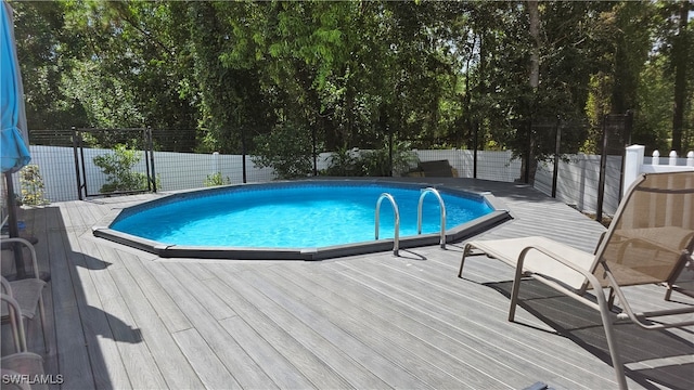 view of swimming pool with a deck