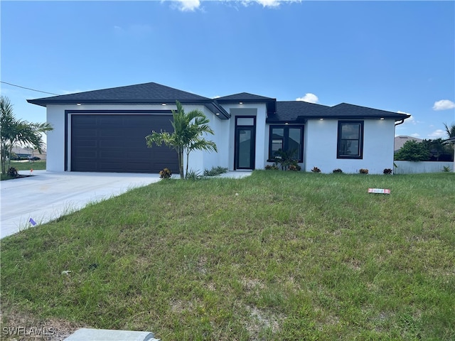 view of front of home featuring a garage and a front lawn