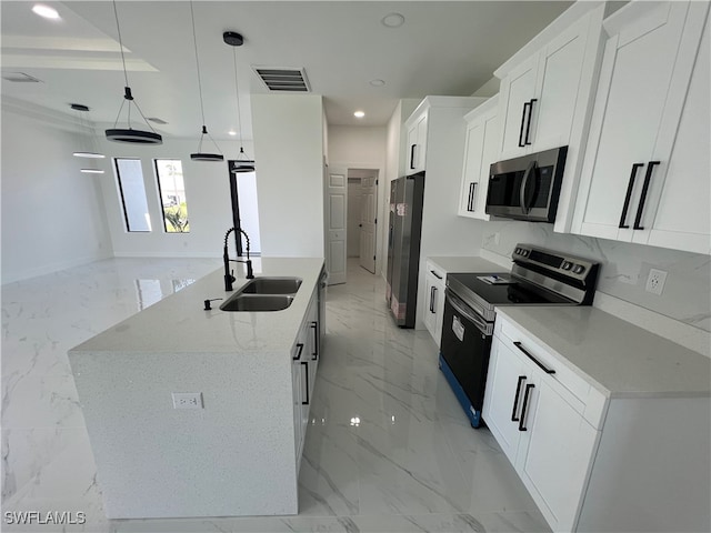 kitchen featuring appliances with stainless steel finishes, decorative light fixtures, sink, a center island with sink, and light tile patterned floors