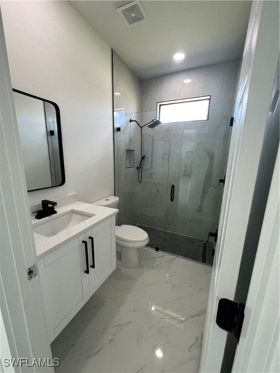 bathroom with tile patterned flooring, an enclosed shower, vanity, and toilet