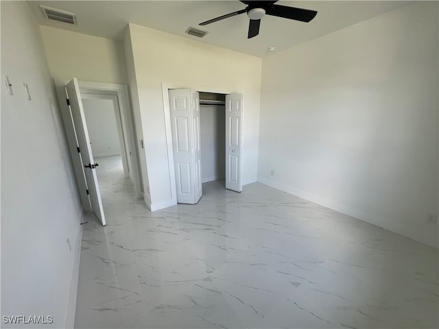 unfurnished bedroom featuring ceiling fan, a closet, and light tile patterned flooring