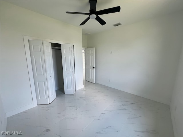 unfurnished bedroom featuring ceiling fan, light tile patterned floors, and a closet