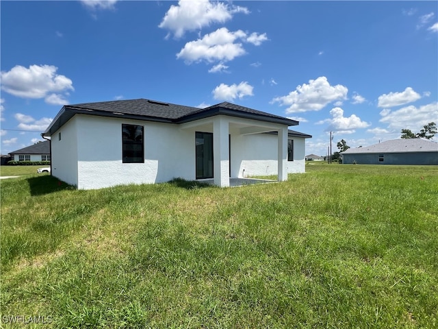 back of property featuring a lawn