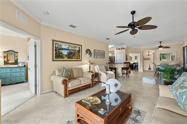 living area featuring ornamental molding, visible vents, and light tile patterned floors