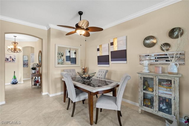 dining space with arched walkways, ornamental molding, and baseboards