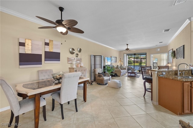 dining space with ornamental molding, a ceiling fan, visible vents, and light tile patterned floors