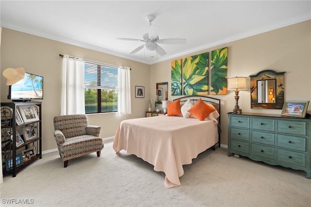 bedroom with baseboards, ornamental molding, a ceiling fan, and light colored carpet