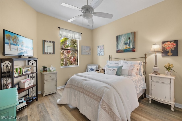 bedroom with baseboards, ceiling fan, and light wood finished floors