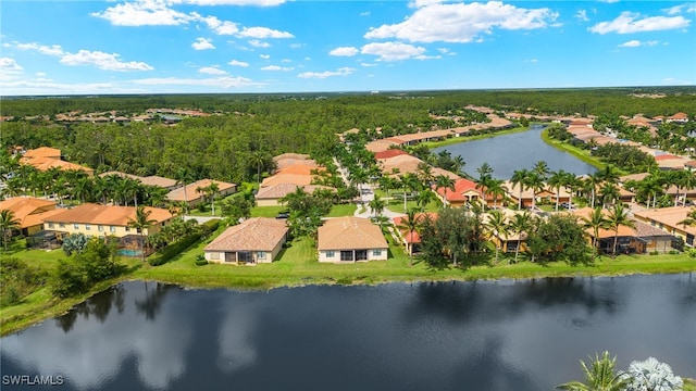 bird's eye view featuring a residential view, a water view, and a wooded view