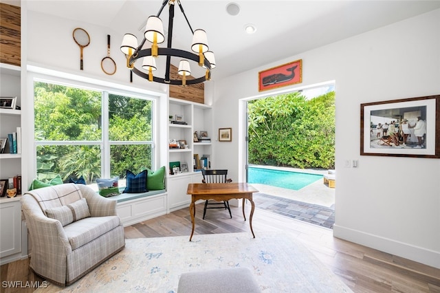 living area with a notable chandelier and light hardwood / wood-style floors