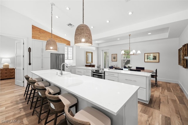 kitchen featuring plenty of natural light, pendant lighting, and appliances with stainless steel finishes