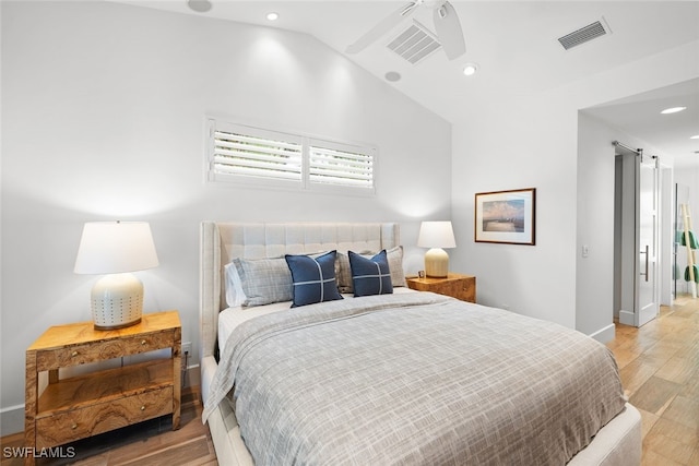 bedroom featuring ceiling fan, vaulted ceiling, and light wood-type flooring