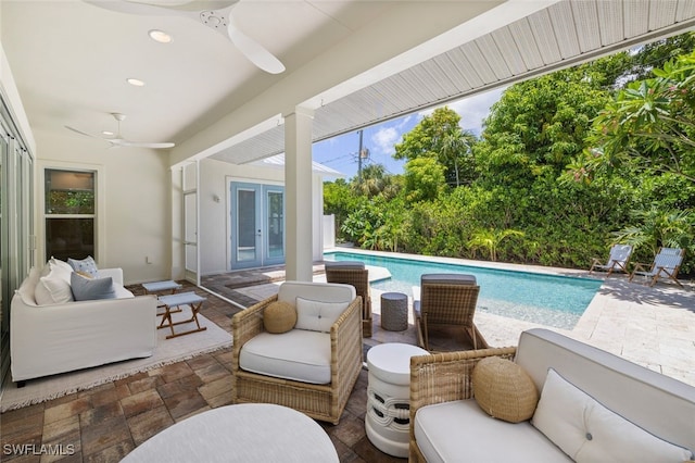 view of swimming pool featuring outdoor lounge area, ceiling fan, french doors, and a patio area