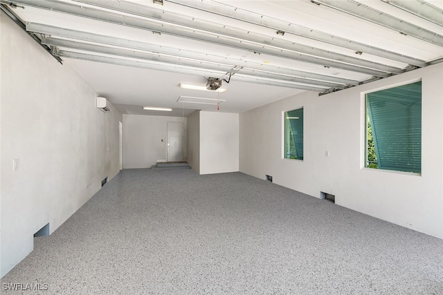 garage with an AC wall unit and a garage door opener