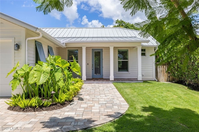 view of exterior entry featuring a yard