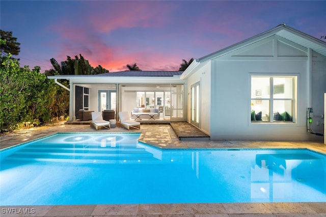 view of pool at dusk