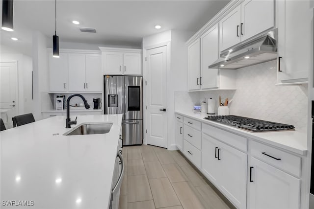 kitchen with sink, white cabinetry, pendant lighting, stainless steel appliances, and decorative backsplash