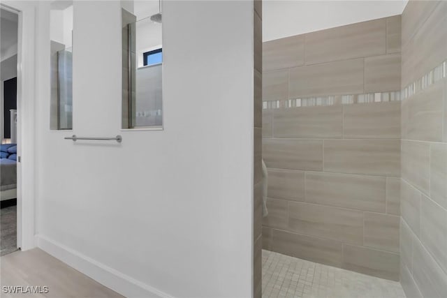 bathroom with tiled shower