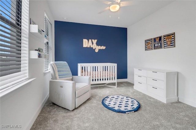 carpeted bedroom with a nursery area