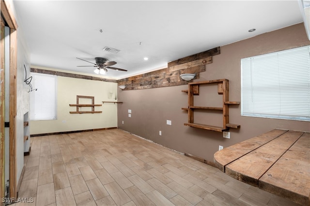 unfurnished room with ceiling fan and light hardwood / wood-style floors