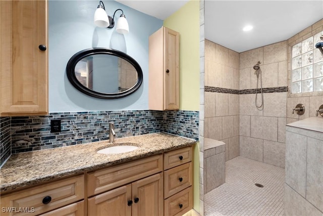 1418 Shirley Dr, North Fort Myers, FL 33917 - bathroom featuring a tile shower, vanity, and decorative backsplash