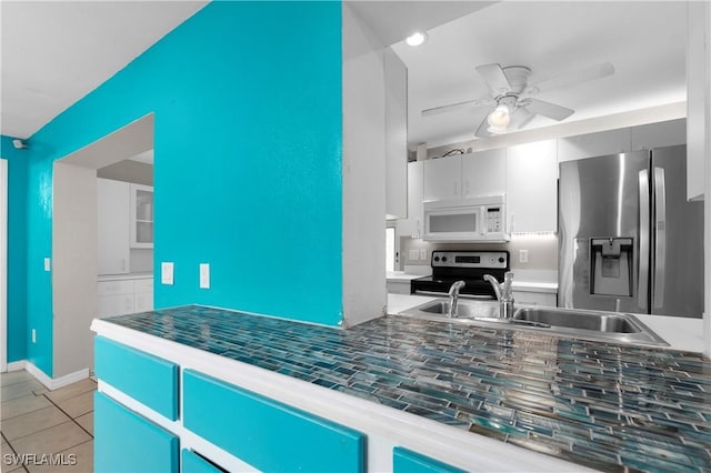 1418 Shirley Dr, North Fort Myers, FL 33917 - kitchen featuring light tile patterned floors, ceiling fan, a sink, appliances with stainless steel finishes, and dark countertops