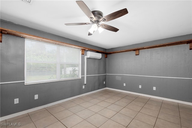 tiled empty room featuring ceiling fan and a wall mounted air conditioner