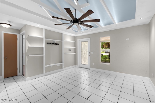 interior space with ceiling fan and a tray ceiling