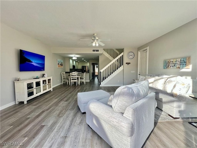 living room with hardwood / wood-style floors and ceiling fan