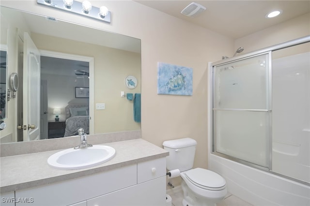 full bathroom with vanity, toilet, enclosed tub / shower combo, and tile patterned flooring