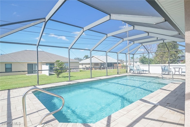 view of pool featuring a yard, a patio area, and a lanai