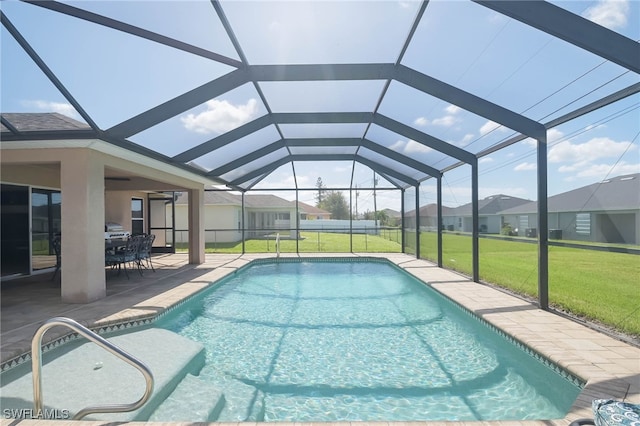 view of pool with a lanai and a lawn