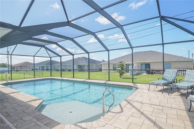 view of pool with a lawn, a patio, and glass enclosure