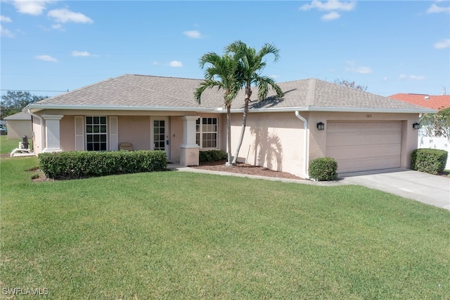 single story home featuring a garage and a front lawn