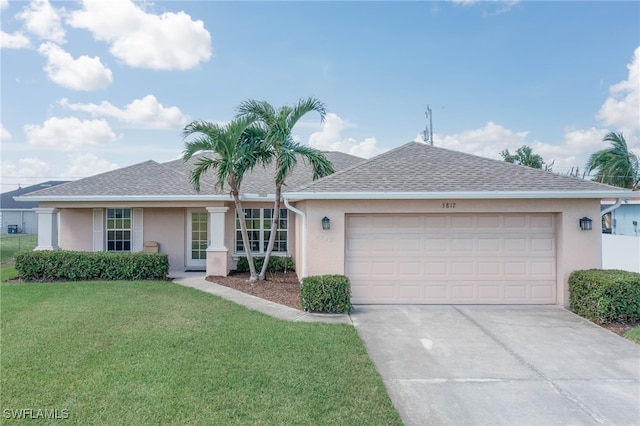 single story home with a front yard and a garage