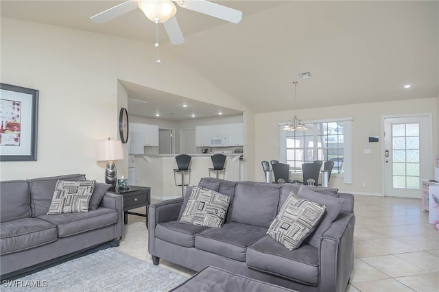 living room with light tile patterned flooring, high vaulted ceiling, and ceiling fan with notable chandelier